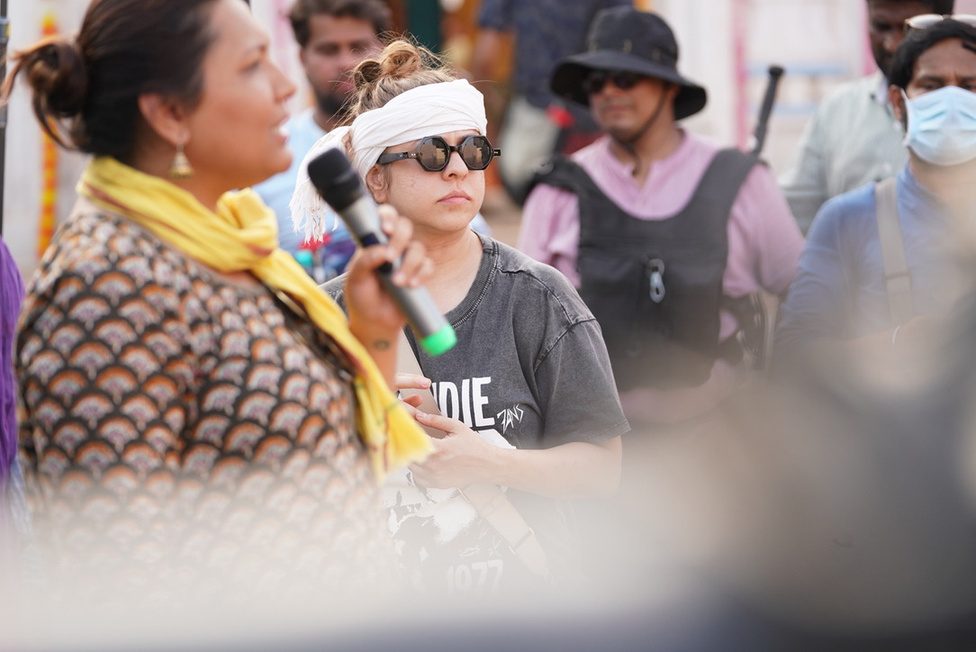 A director giving instructions through a megaphone on the Dupahiya set