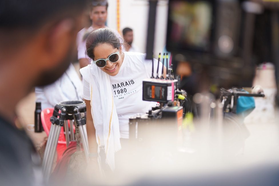 The Bombay Film Cartel founders with a collaborator, seated together on location